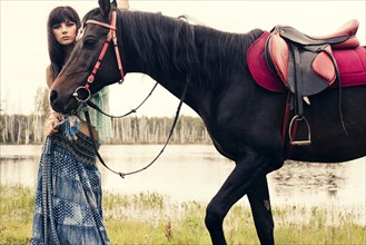 Caucasian woman walking with horse outdoors