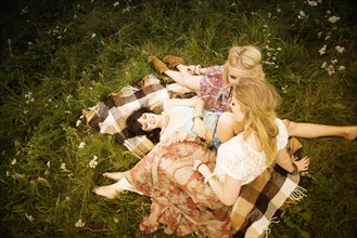 Caucasian women relaxing in field
