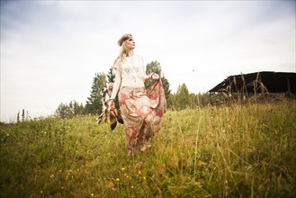 Caucasian woman walking in field