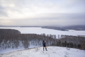 Caucasian woman standing on snowy hilltop