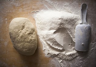 High angle view of flour and dough on table