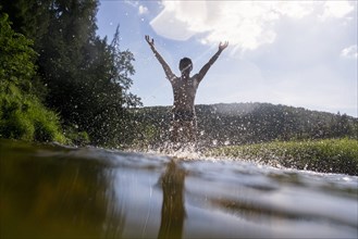 Mari man splashing in lake