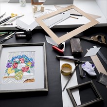 Picture frame and tools on table