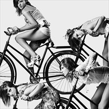 Multiple exposure of Caucasian girl riding bicycle