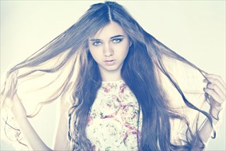 Portrait of Caucasian teenage girl pulling hair