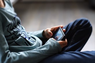 Close up of Caucasian boy playing with cell phone