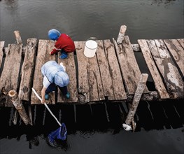 Boys playing on wooden dock