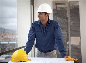 Hispanic man in hard-hat on construction site