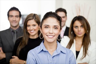 Hispanic business people standing together in office