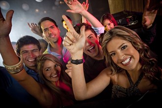 Hispanic friends dancing in nightclub