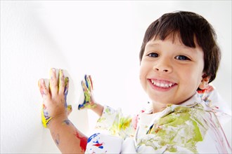 Hispanic boy finger painting