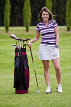 Hispanic woman playing golf