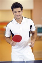 Hispanic man playing ping pong