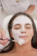 Woman having facial spa treatment