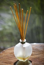 Sticks of incense in glass jar