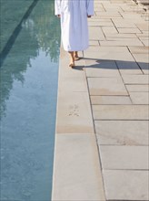 Woman walking near swimming pool