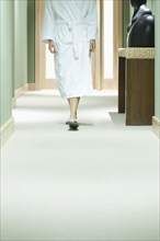 Mixed race woman walking in spa corridor