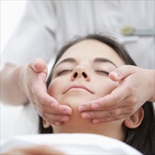 Woman having spa facial treatment