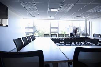 Caucasian businessman working in empty conference room
