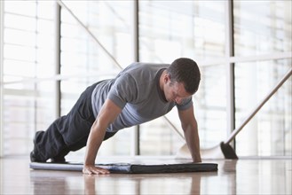Man doing push-ups in health club