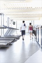 Couple walking together in health club
