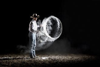 Caucasian cowboy spinning lasso