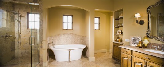 Contemporary master bath with glass shower and modern bathtub