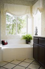 Simple bathtub in corner with windows
