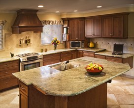Traditional kitchen with large island and green countertops
