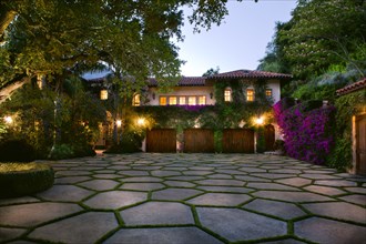 Stone shape tiled driveway in front of a Spanish style home