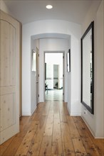Hallway with mirror on wall in home