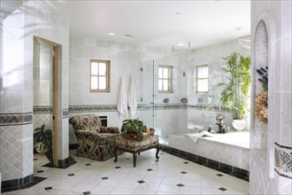 Interior of domestic bathroom with armchair and stool