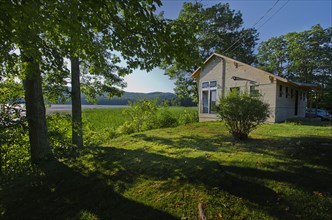 Scenic shot of a cabin with clapboard siding by lake at Burlington