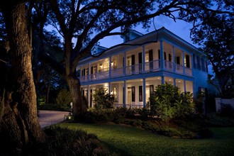 Front exterior plantation style home at dusk