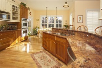 Granite countertop in domestic kitchen with hardwood flooring