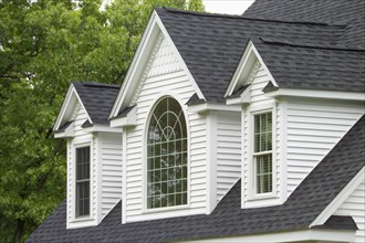 Window with shingled roof of single family home