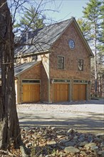 Exterior of single family home with wooden doors at garage
