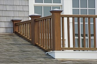 Wooden balcony railing and shingled roof
