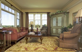 Traditional living room with area rug and picture window
