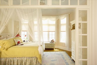 Girls bedroom with bay window and mosquito netting