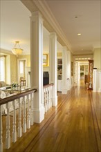 Traditional hallway in home with red oak hardwood floors