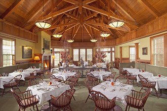 Grand dining room with several tables and wooden ceilings