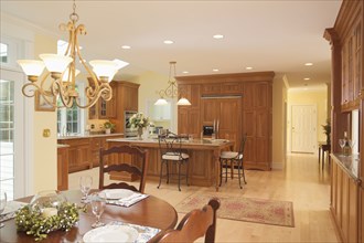 Spacious traditional kitchen with wooden cabinets and dining area