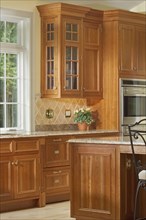 Section of large kitchen with wooden cabinetry