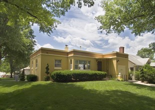 Exterior view of a yellow house with front yard at Lincoln