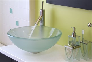 Faucet with running water in contemporary bowl sink