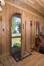 Interior view of front door looking outside in cabin style home