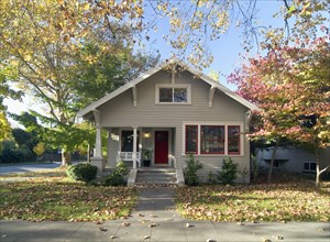 Front exterior gray bungalow with red door