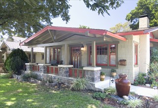 Exterior one story bungalow with red trim