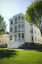 Exterior of multi level apartment home with porches